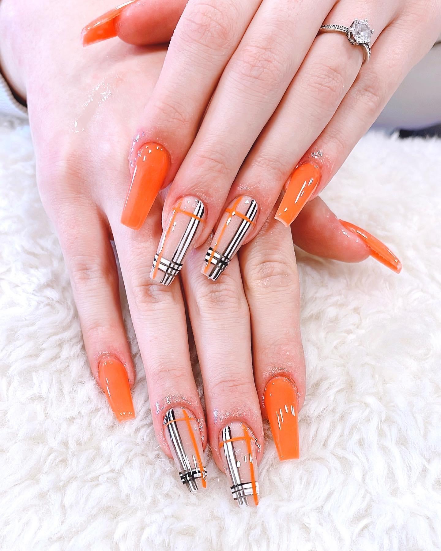 Long coffin acrylics in bright orange with a tartan check design