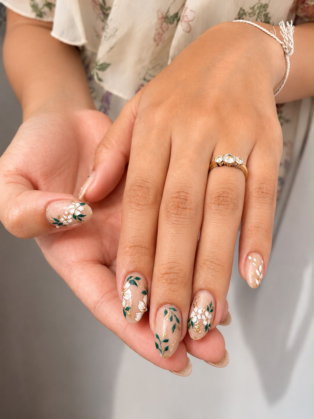 Short almond nails, nude with green floral art