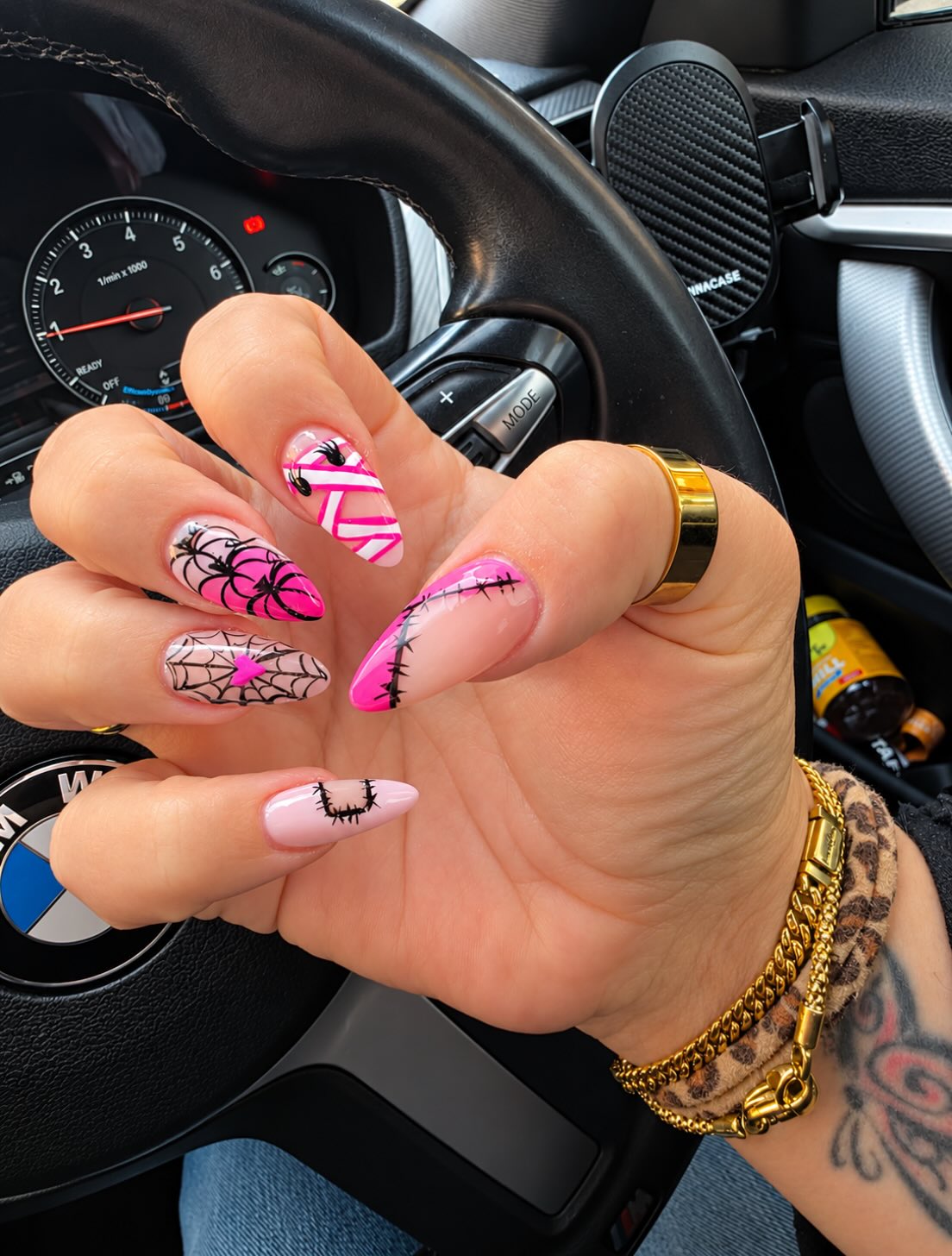 Pink stiletto nails with black spider web art